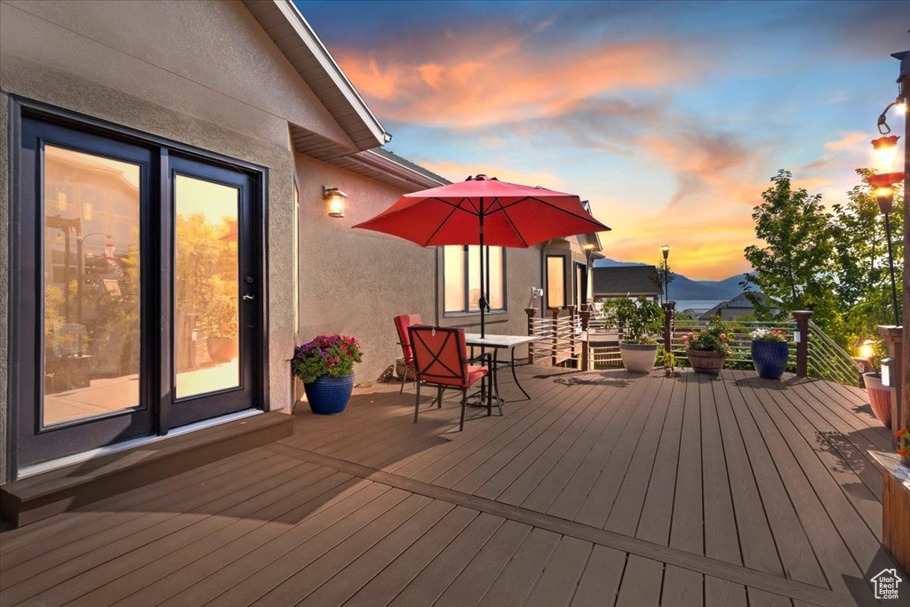 Deck at dusk featuring outdoor dining area