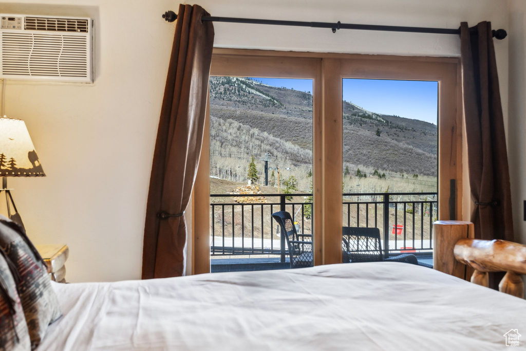 Bedroom featuring access to exterior, a mountain view, and a wall mounted AC