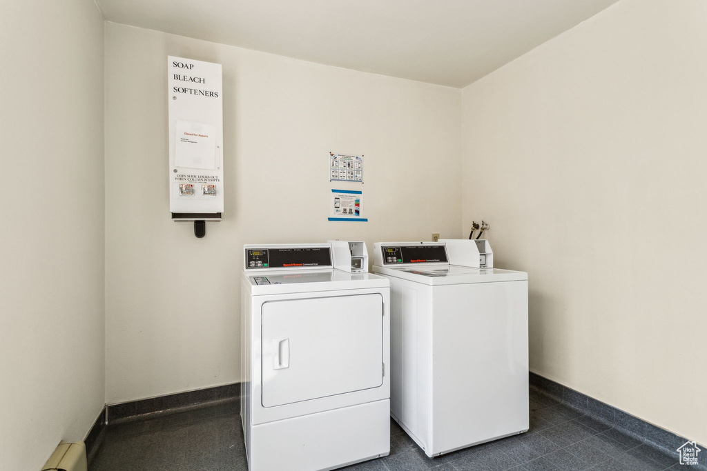 Shared laundry area featuring a baseboard radiator, washer and clothes dryer, and baseboards