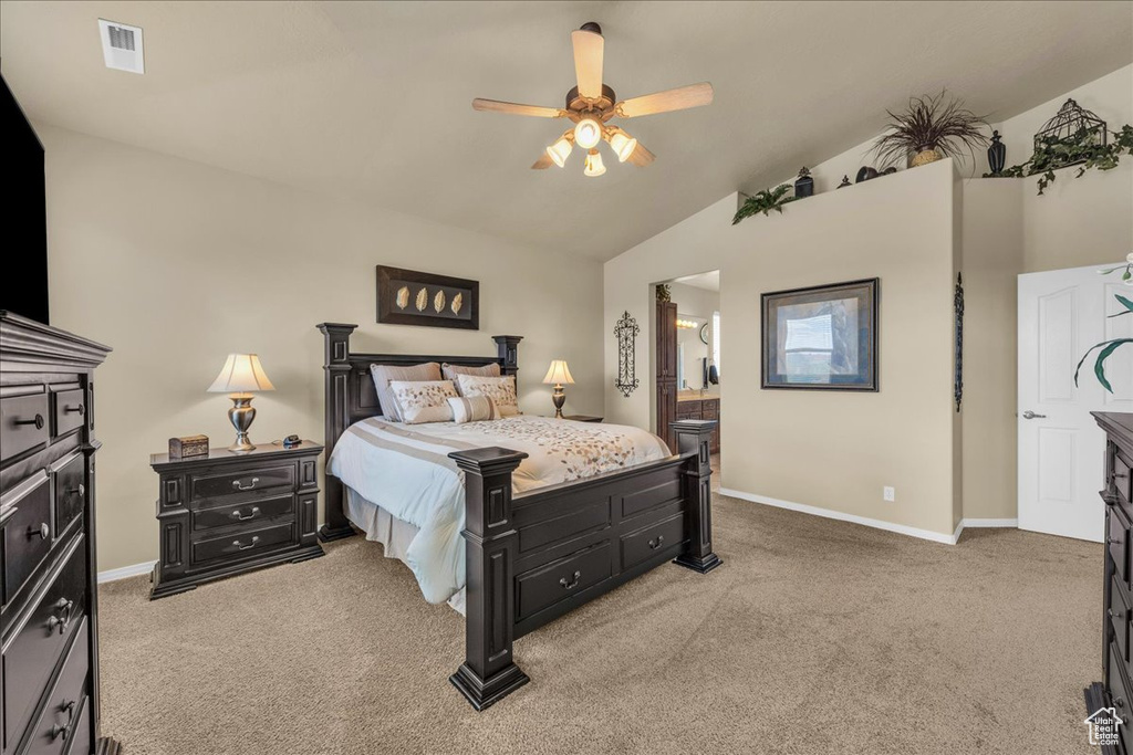 Bedroom with a ceiling fan, visible vents, vaulted ceiling, baseboards, and light carpet