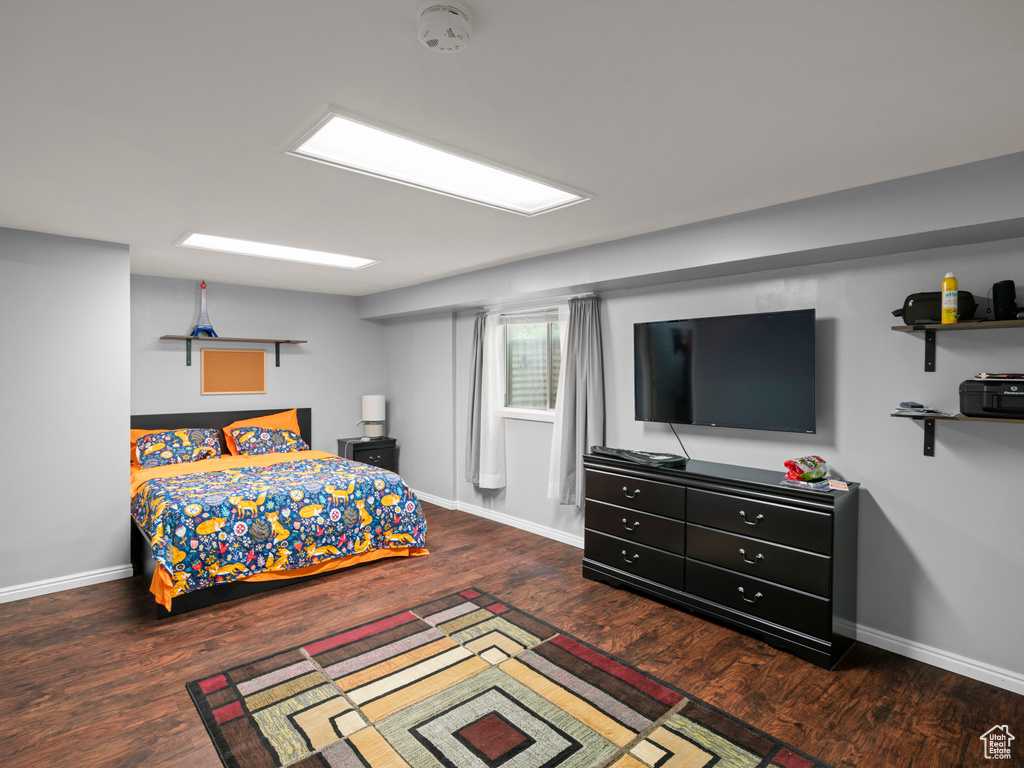 Bedroom with baseboards and wood finished floors