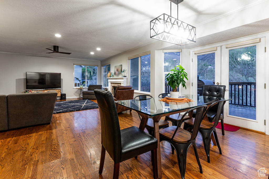 Dining area with recessed lighting, baseboards, ornamental molding, and dark wood-style floors