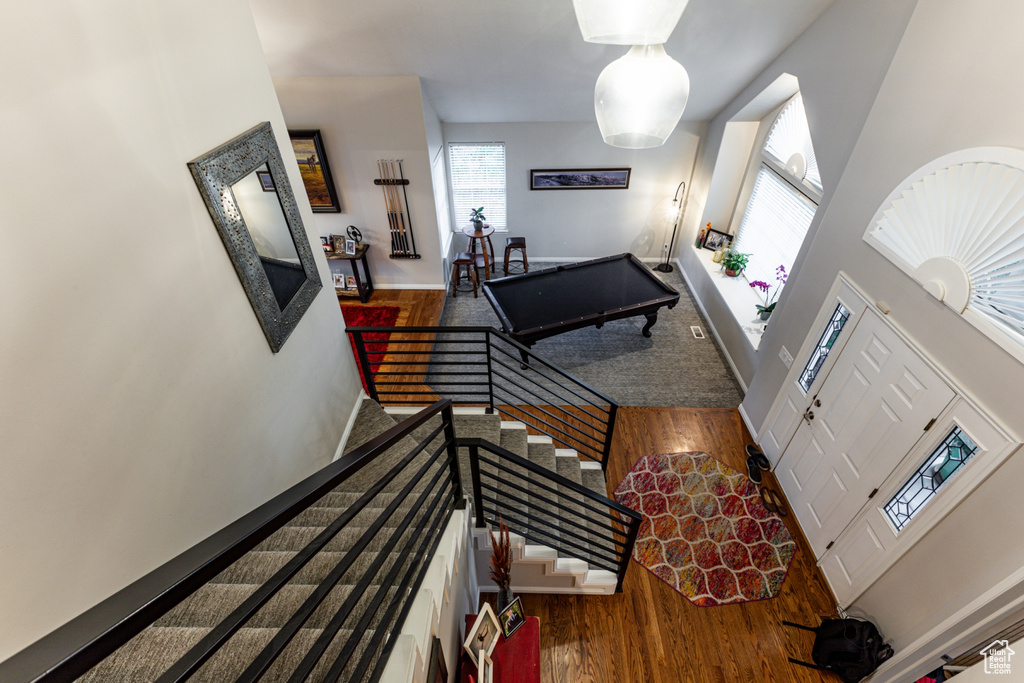 Interior space with baseboards, a high ceiling, and wood finished floors