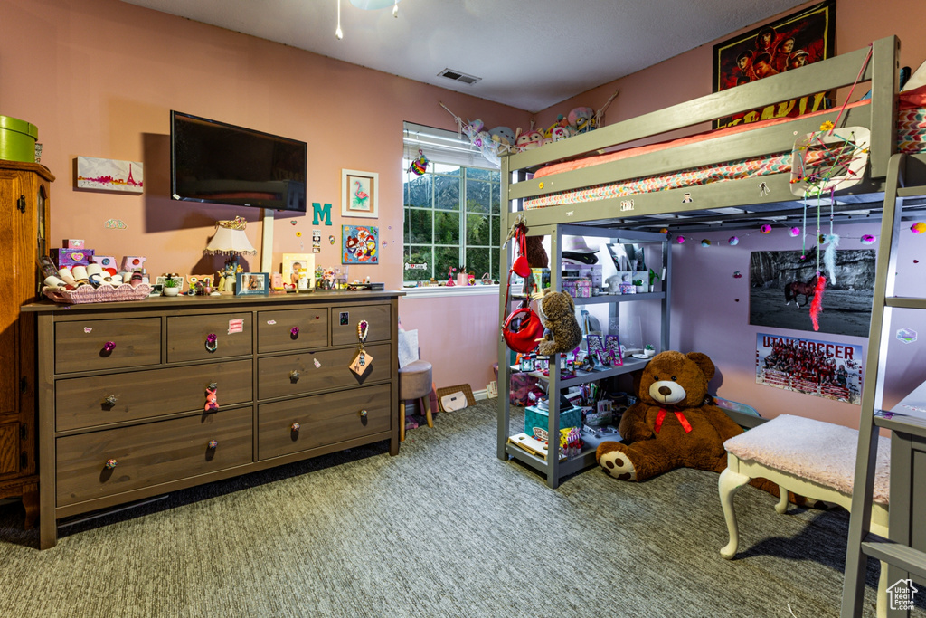 Carpeted bedroom featuring visible vents