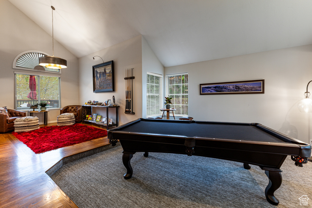 Rec room with baseboards, billiards, wood finished floors, and high vaulted ceiling