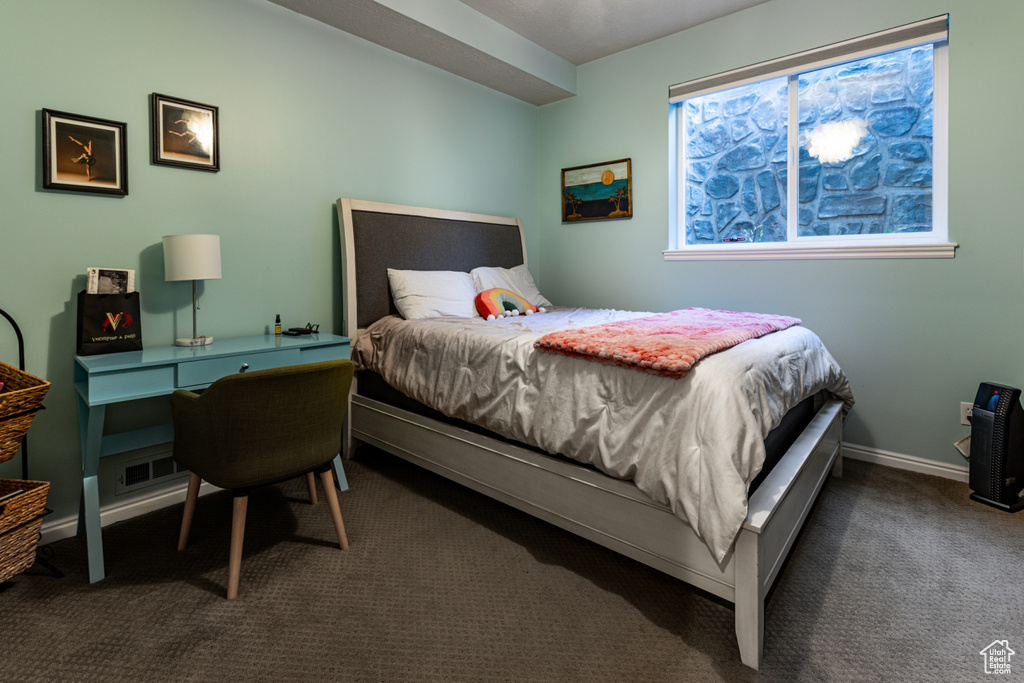 Carpeted bedroom with baseboards and visible vents