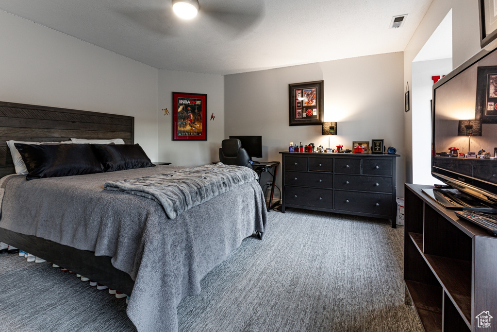 Bedroom featuring a ceiling fan, carpet flooring, and visible vents