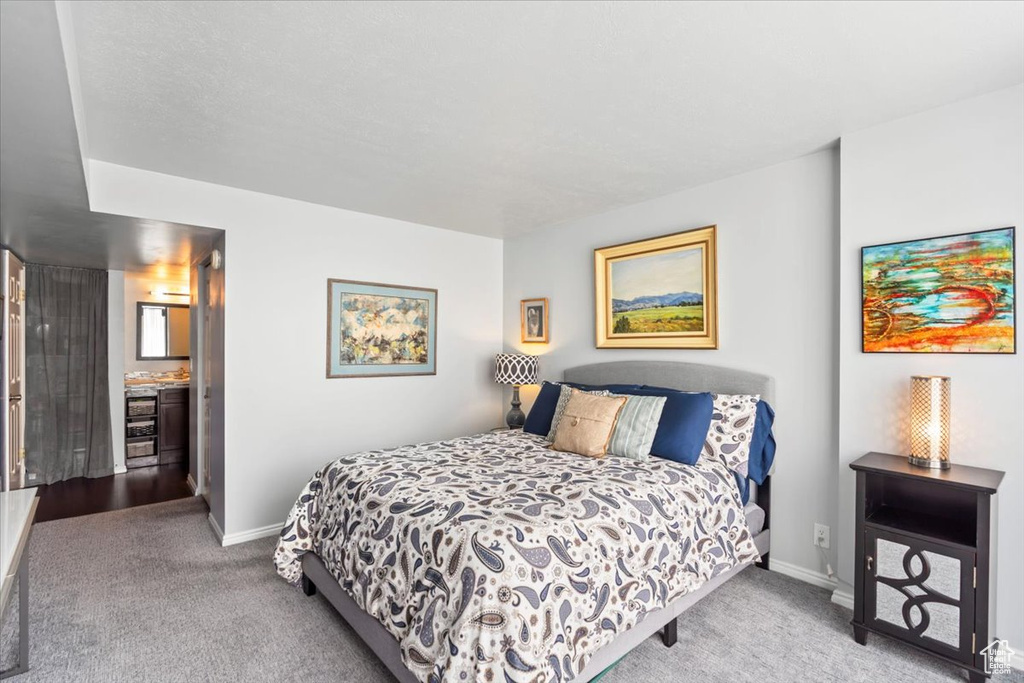 Bedroom featuring carpet floors and baseboards