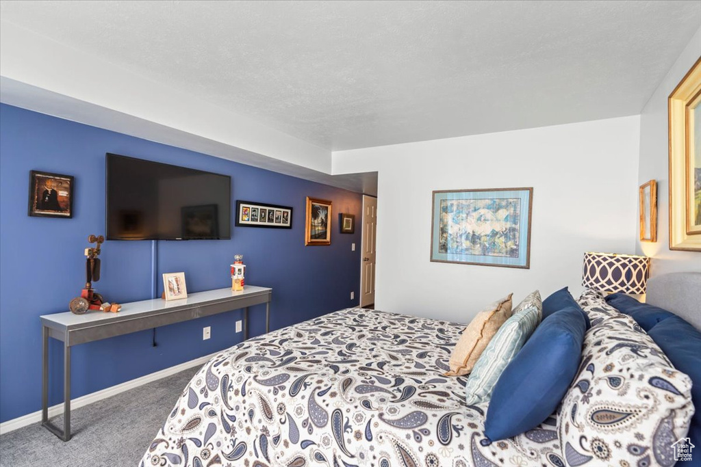 Bedroom featuring carpet floors and baseboards