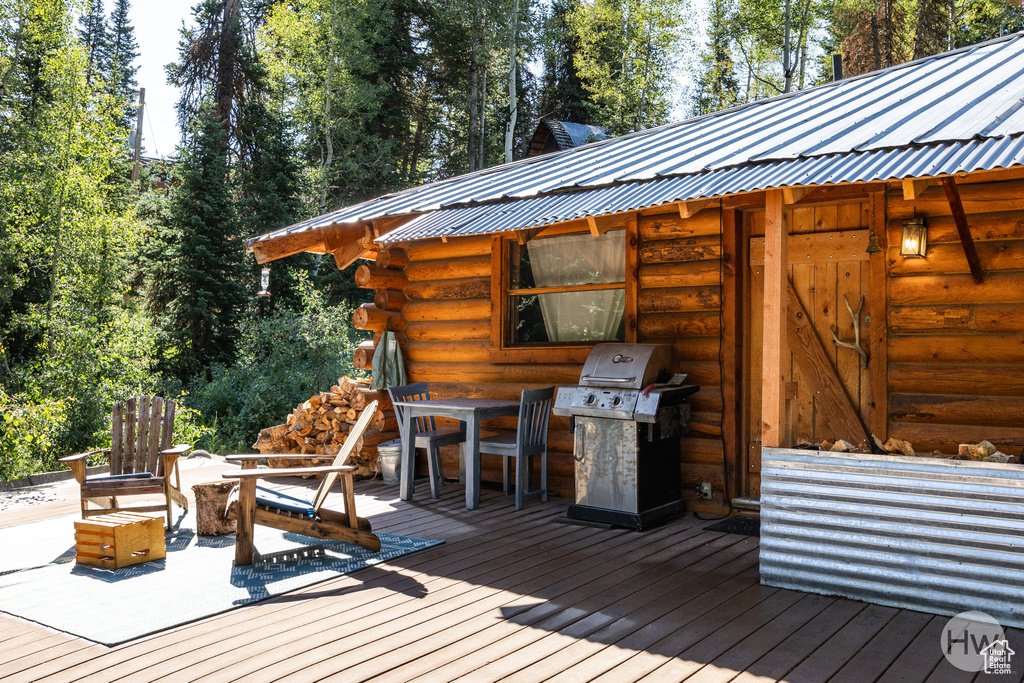Wooden deck with outdoor dining area and a grill