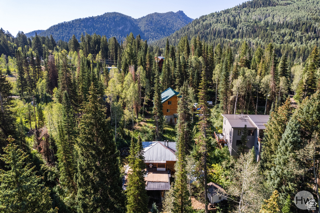 Birds eye view of property with a mountain view and a forest view
