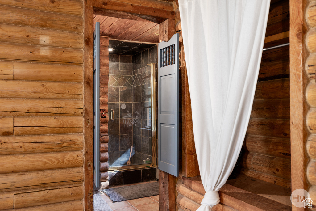 Bathroom featuring log walls