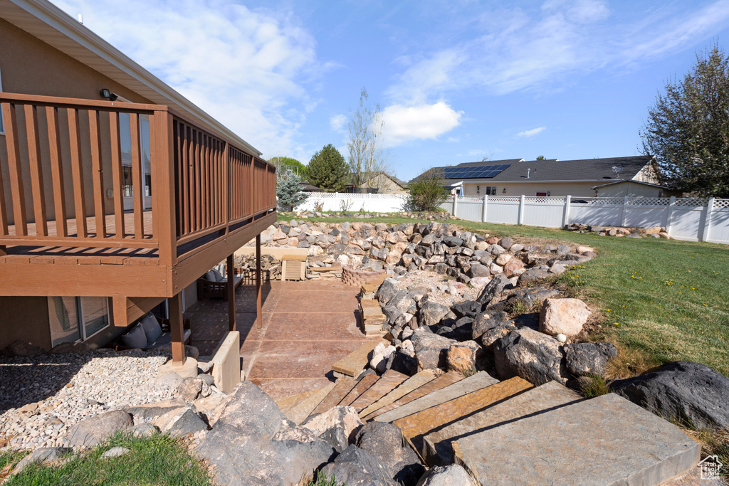 View of yard featuring fence and a wooden deck