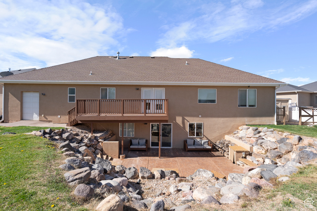 Rear view of house with a deck, stucco siding, an outdoor hangout area, a shingled roof, and a patio area