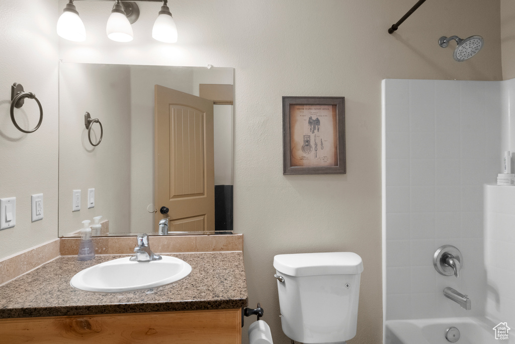 Bathroom with shower / bath combination, vanity, and toilet