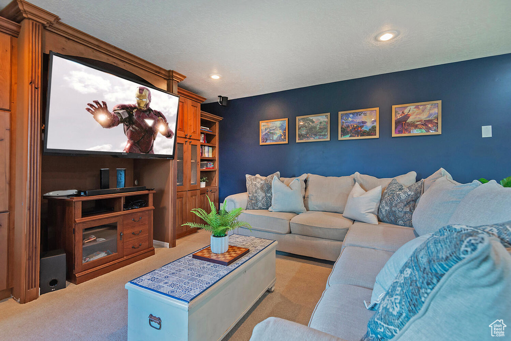 Living room with light colored carpet and recessed lighting