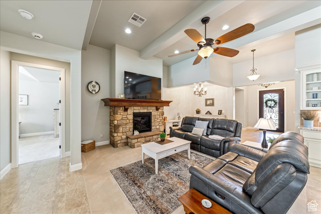 Living room with ceiling fan, visible vents, a fireplace, light carpet, and recessed lighting