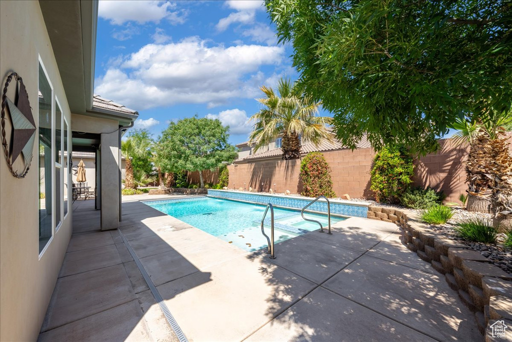 View of swimming pool featuring a fenced in pool, a fenced backyard, and a patio area