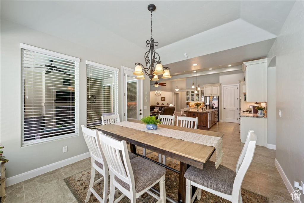 Dining space featuring baseboards, recessed lighting, light tile patterned flooring, and a notable chandelier