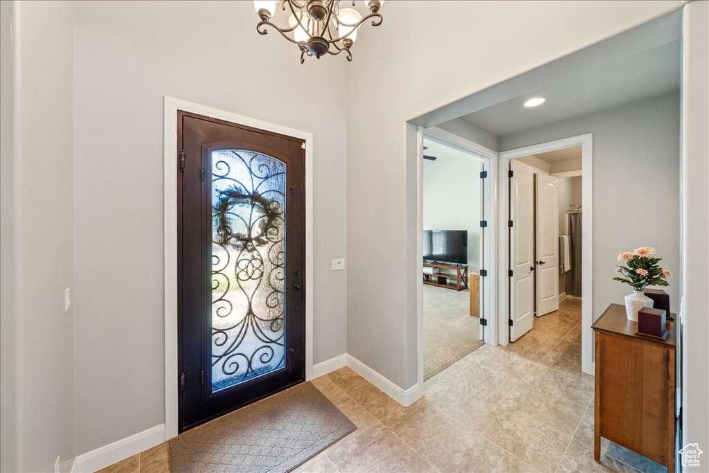 Entrance foyer with recessed lighting, baseboards, a chandelier, and light tile patterned floors