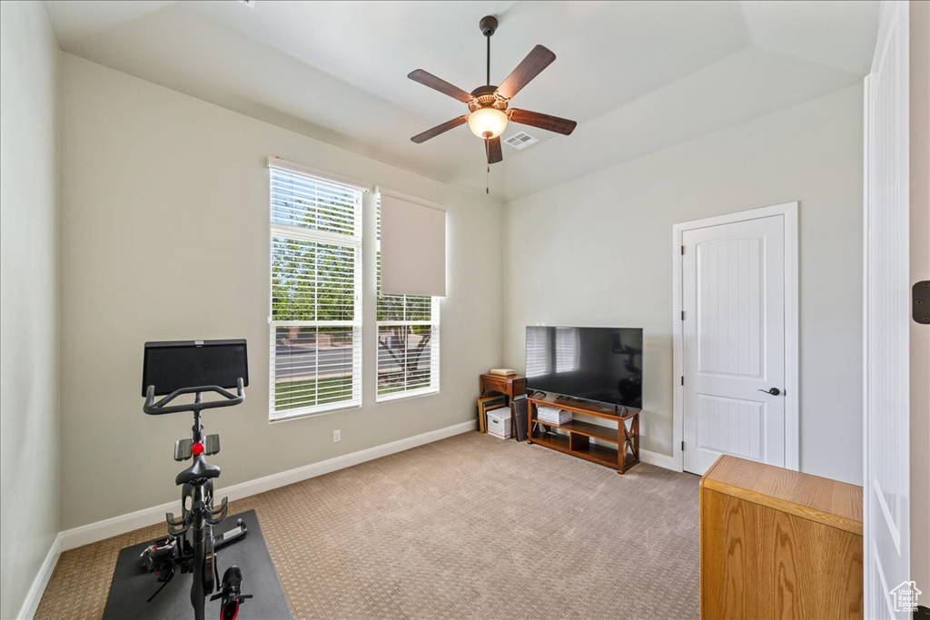 Workout room with baseboards, ceiling fan, carpet, and visible vents