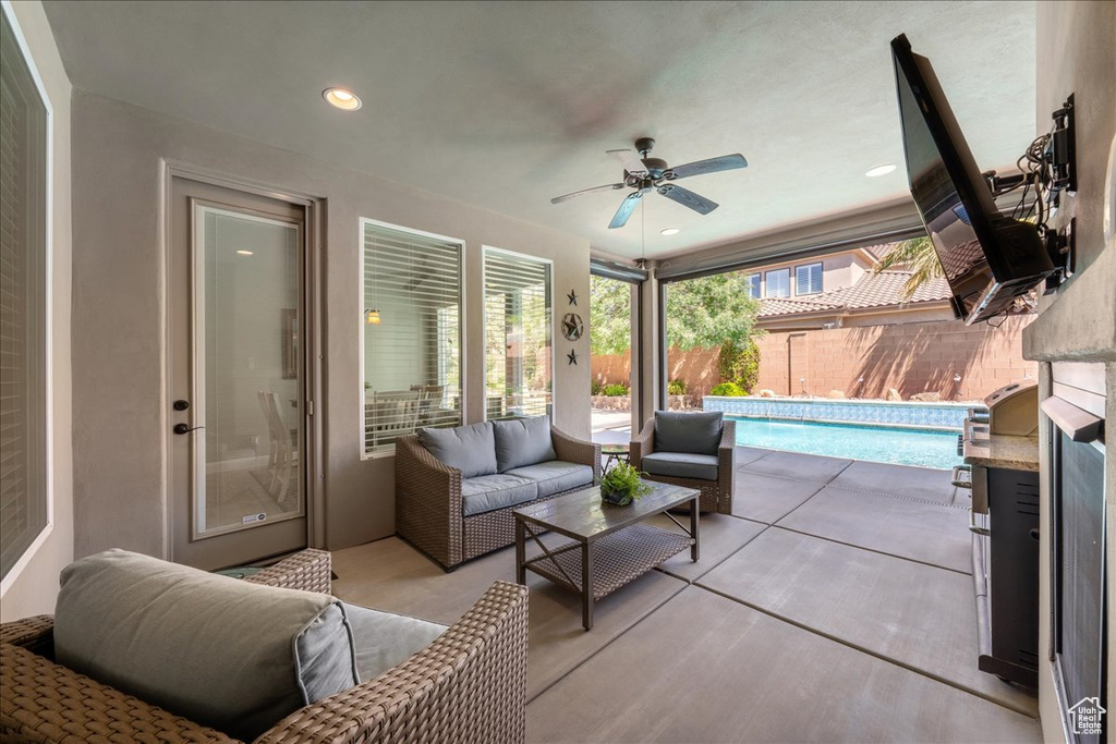 View of patio with ceiling fan, an outdoor living space, a fenced backyard, and a fenced in pool