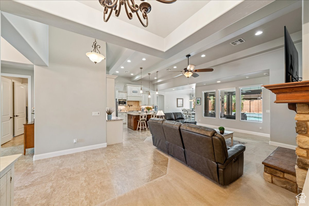 Living room featuring visible vents, recessed lighting, baseboards, and ceiling fan with notable chandelier