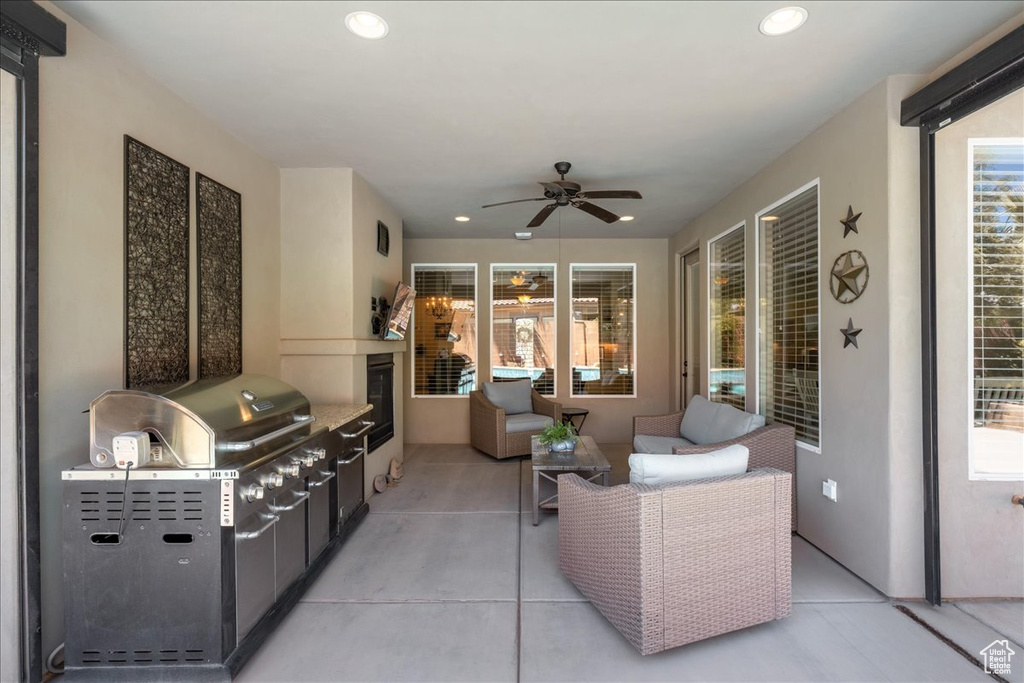 View of patio with grilling area, ceiling fan, and area for grilling