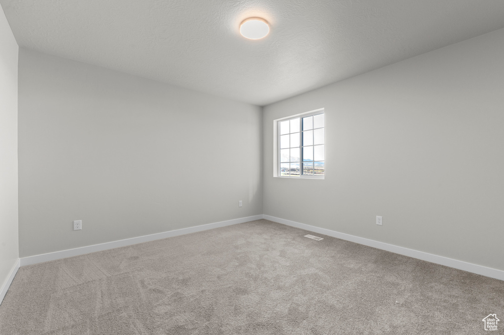 Unfurnished room with carpet floors and baseboards