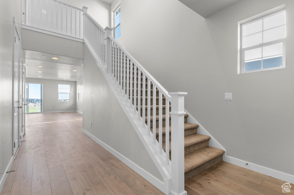 Stairs featuring hardwood / wood-style flooring and baseboards