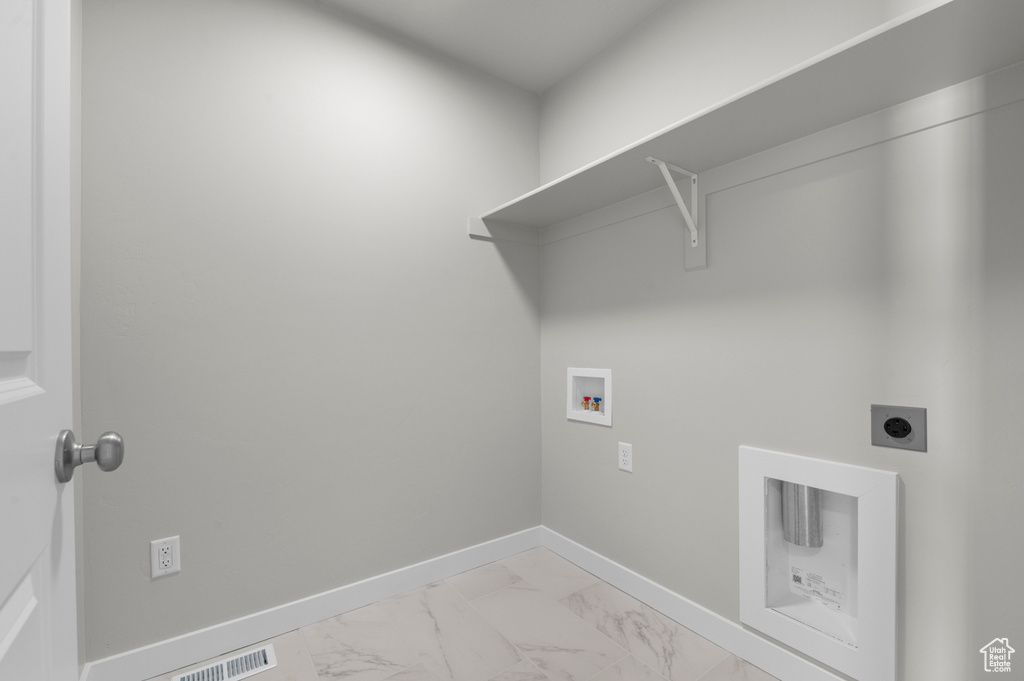 Laundry room with hookup for a washing machine, light marble finish flooring, hookup for an electric dryer, and baseboards