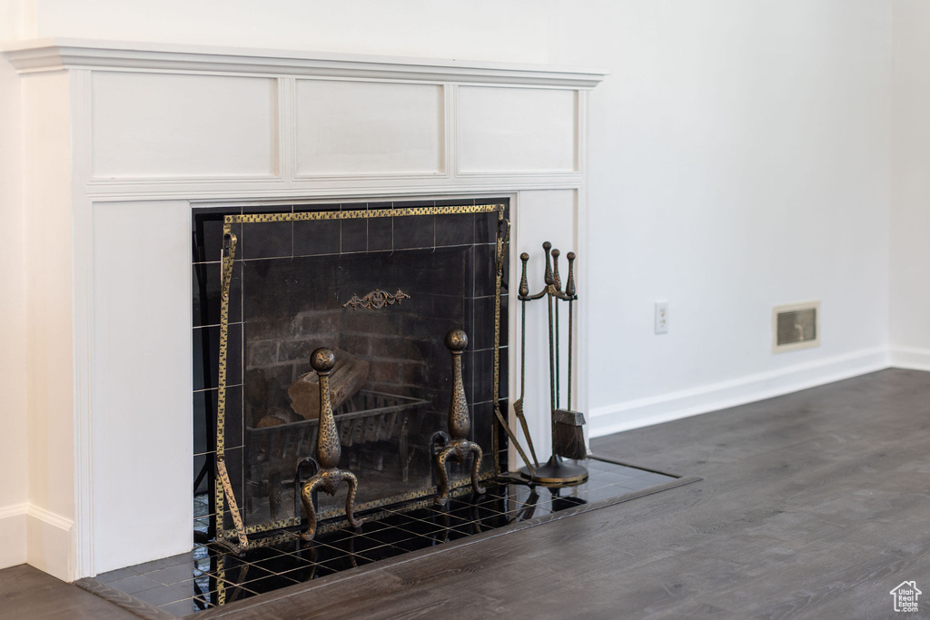 Room details with baseboards, wood finished floors, and visible vents