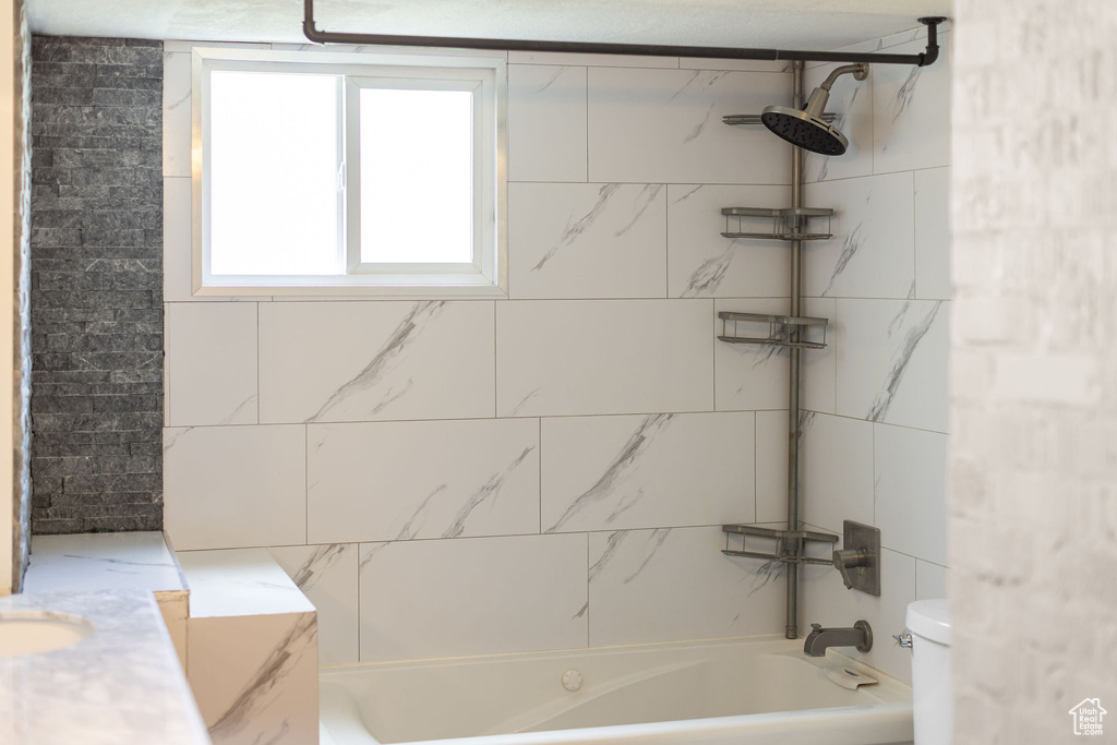 Full bath featuring toilet and  shower combination
