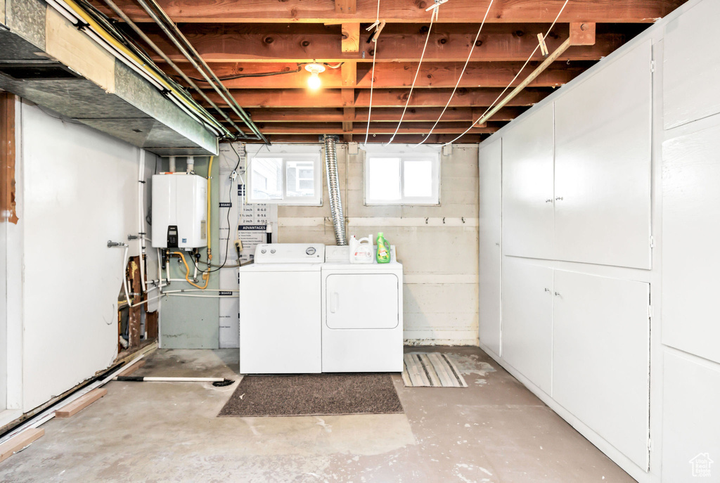 Clothes washing area with tankless water heater, laundry area, and washing machine and clothes dryer