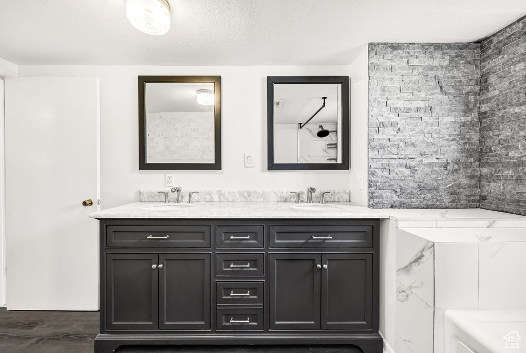 Bathroom featuring a sink and double vanity
