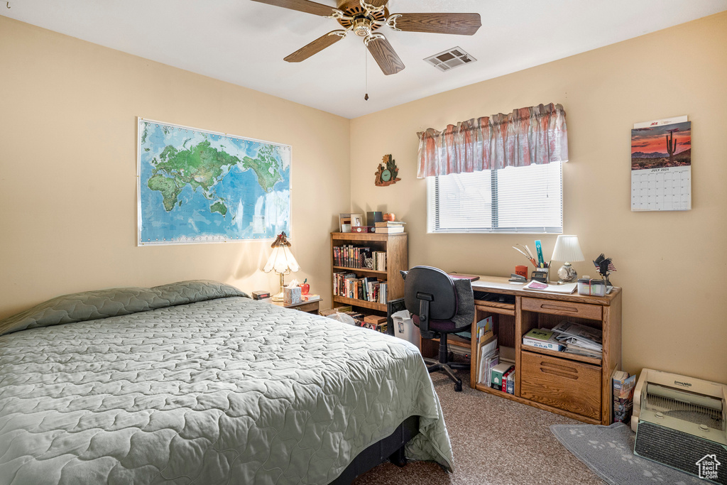 Bedroom with carpet floors, ceiling fan, and visible vents