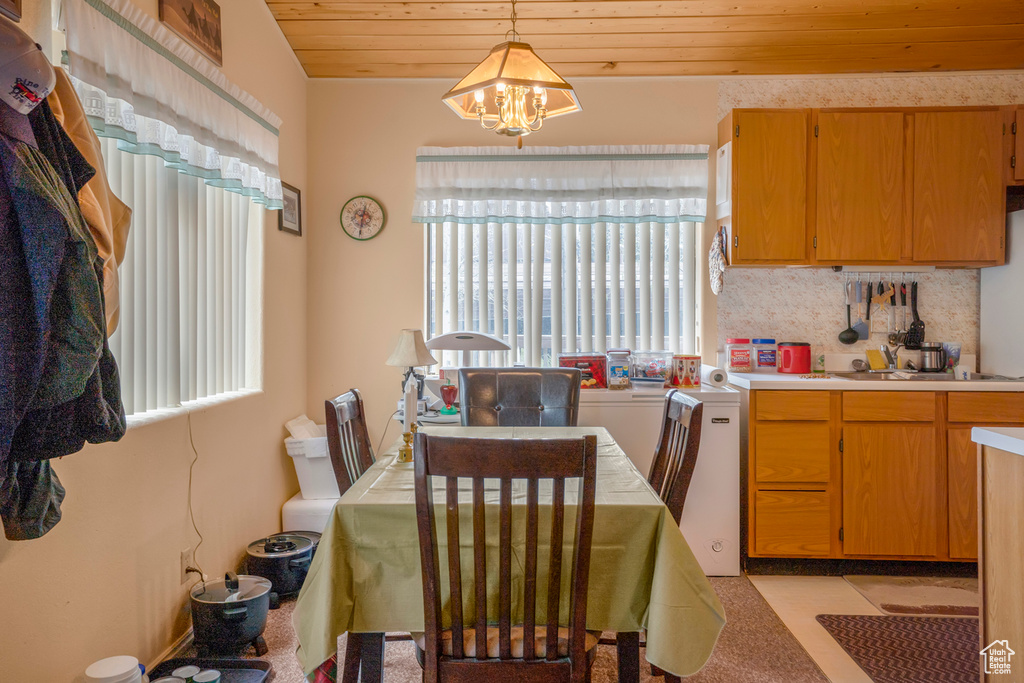 Dining area with wooden ceiling and a chandelier