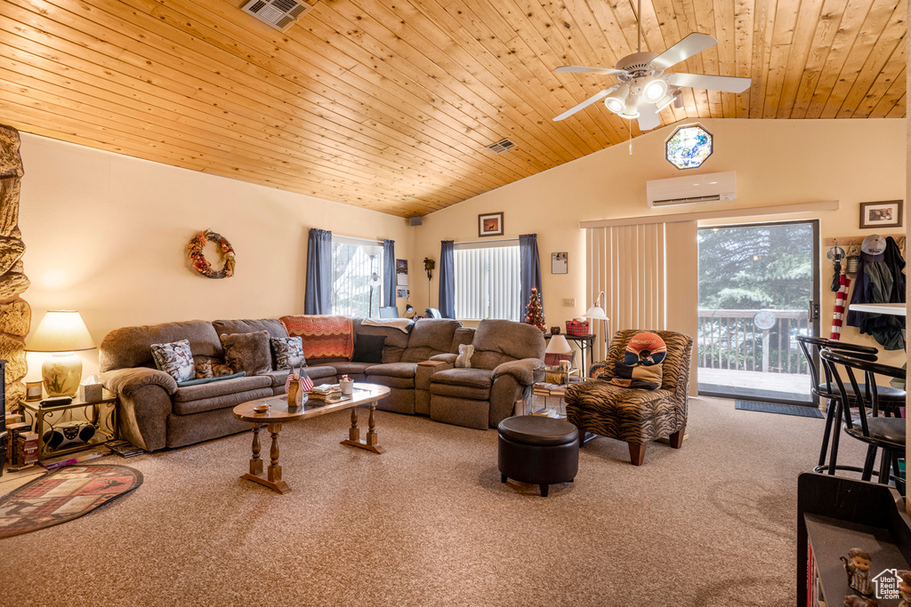 Living room with carpet floors, a ceiling fan, an AC wall unit, and visible vents