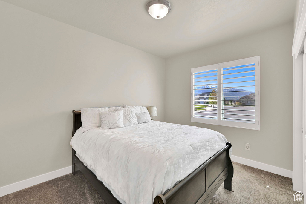 Carpeted bedroom featuring baseboards
