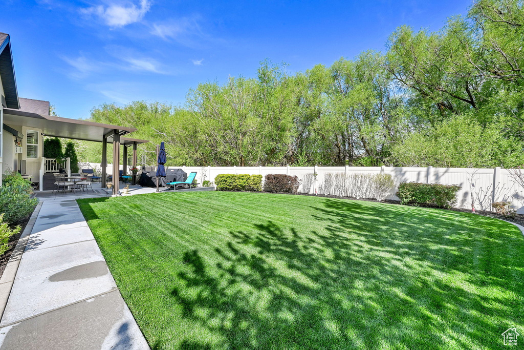 View of yard featuring a fenced backyard and a patio area
