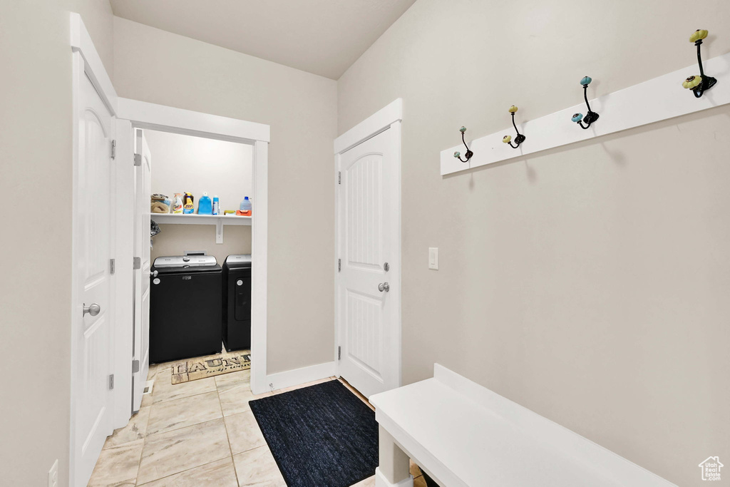 Mudroom with baseboards and washer and dryer