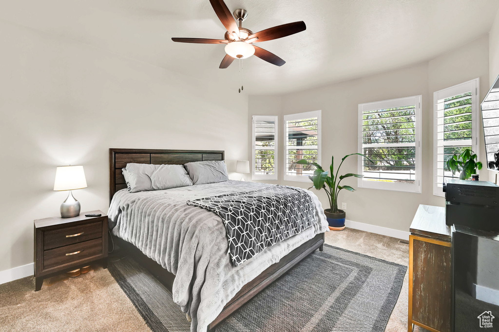 Carpeted bedroom with baseboards and ceiling fan