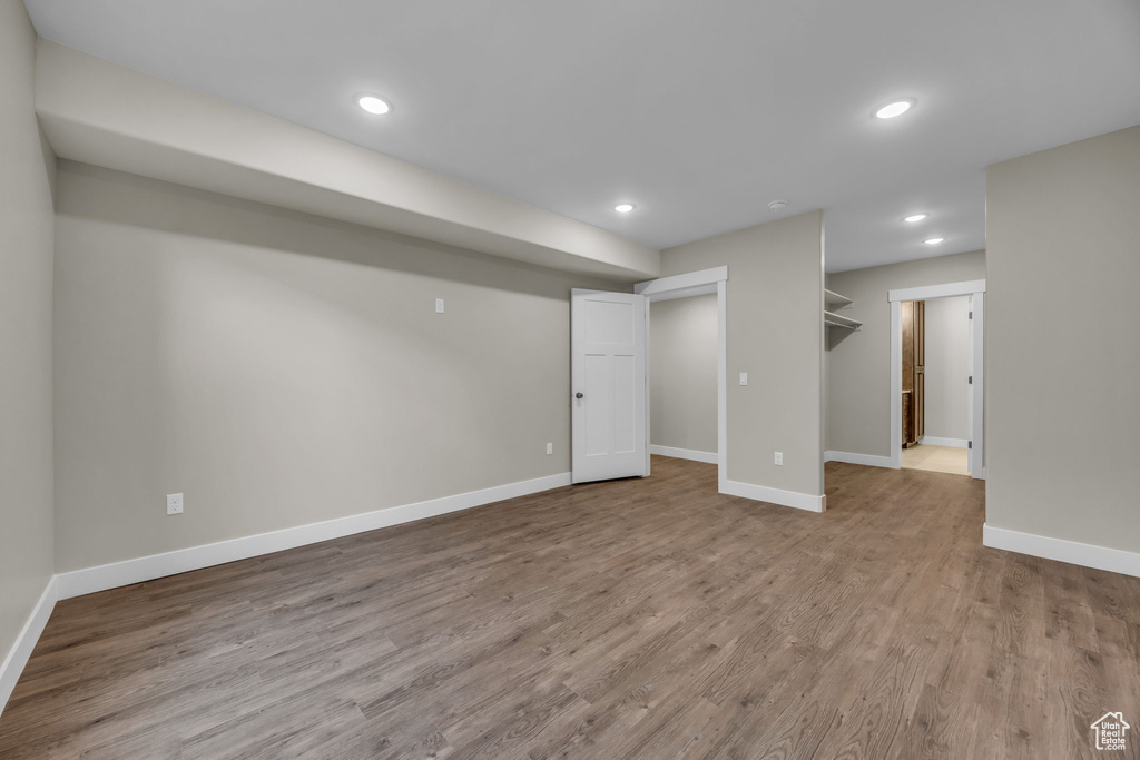 Finished below grade area with baseboards, recessed lighting, and wood finished floors