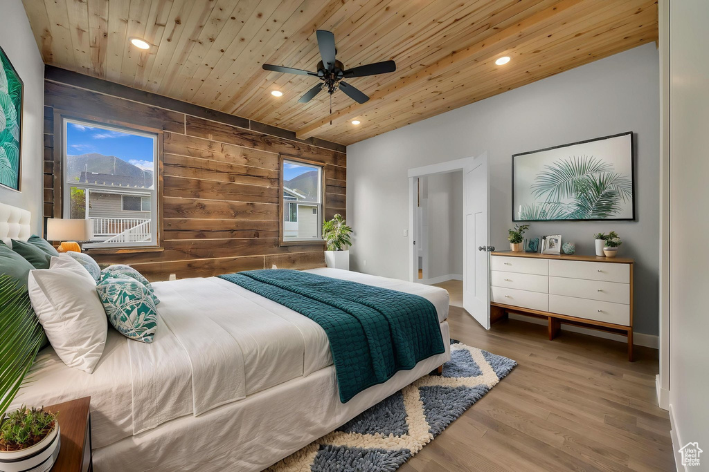 Bedroom with wooden ceiling, recessed lighting, wood finished floors, wood walls, and ceiling fan