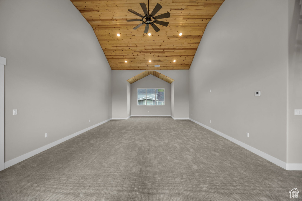 Unfurnished living room featuring a ceiling fan, carpet, high vaulted ceiling, and wooden ceiling