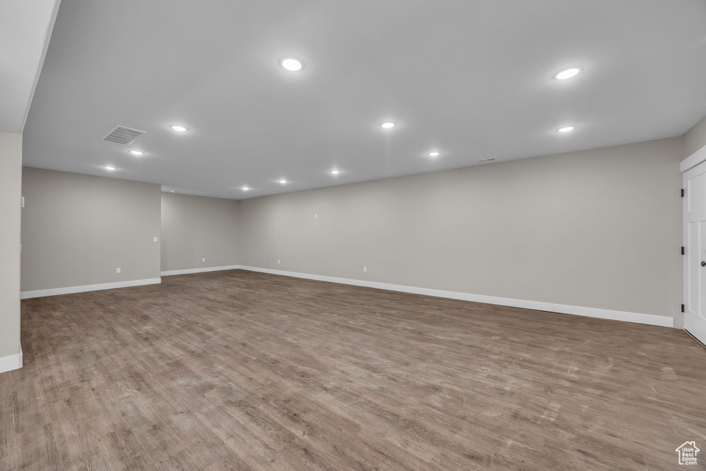 Basement with recessed lighting, baseboards, visible vents, and wood finished floors
