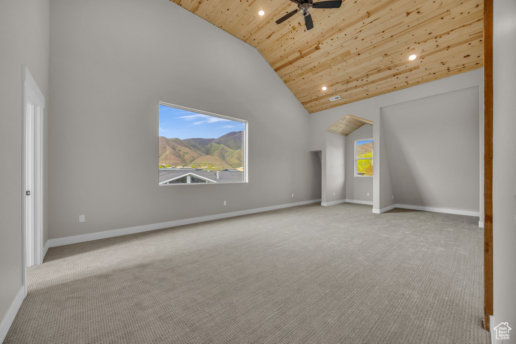 Interior space with recessed lighting, wooden ceiling, carpet, and high vaulted ceiling