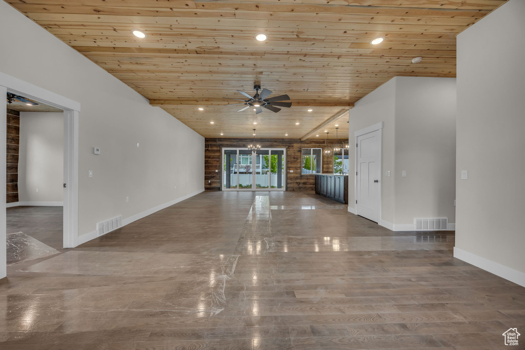 Unfurnished living room with wood ceiling, baseboards, a ceiling fan, and visible vents