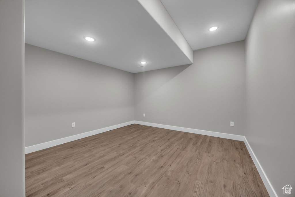 Finished basement with baseboards, recessed lighting, and wood finished floors