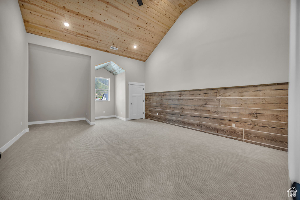 Additional living space with wood ceiling, baseboards, high vaulted ceiling, carpet flooring, and recessed lighting